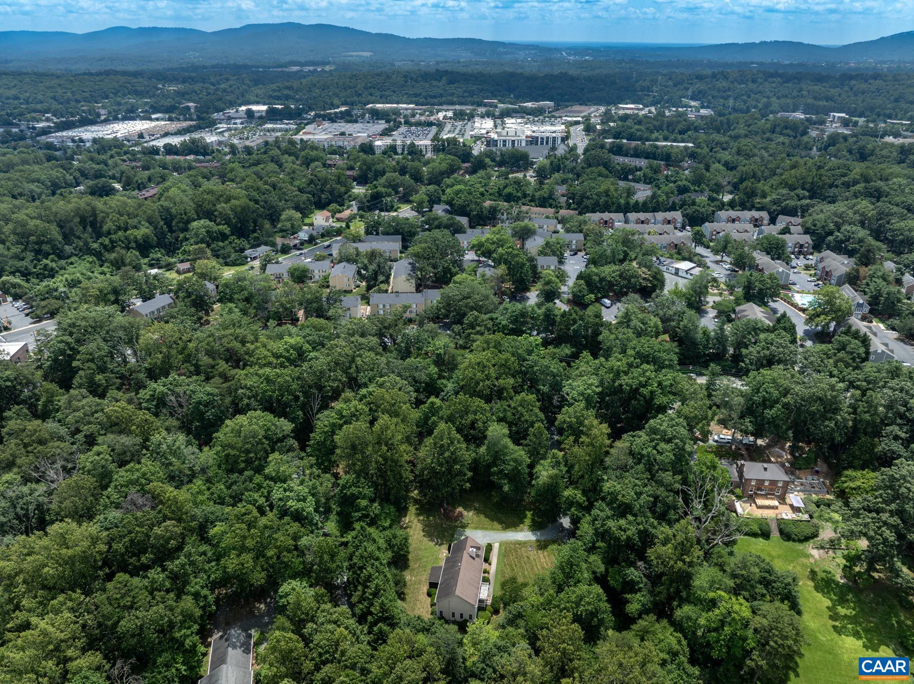 505 Georgetown Road Charlottesville, VA 22901 - Photo 14 of 73 an aerial view of a house with a lush green forest