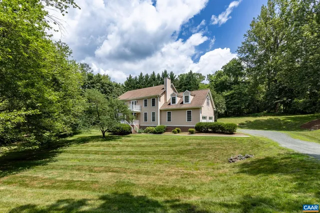 a view of an empty room with wooden floor and window