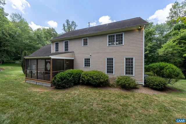 a kitchen with white cabinets and sink