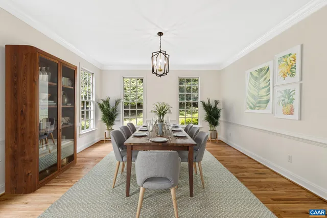 a living room with furniture kitchen view and a wooden floor
