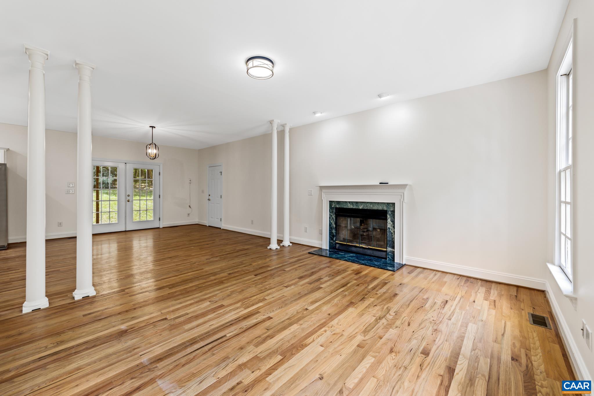 505 Georgetown Road Charlottesville, VA 22901 - Photo 41 of 73 a view of an empty room with wooden floor fireplace and a window