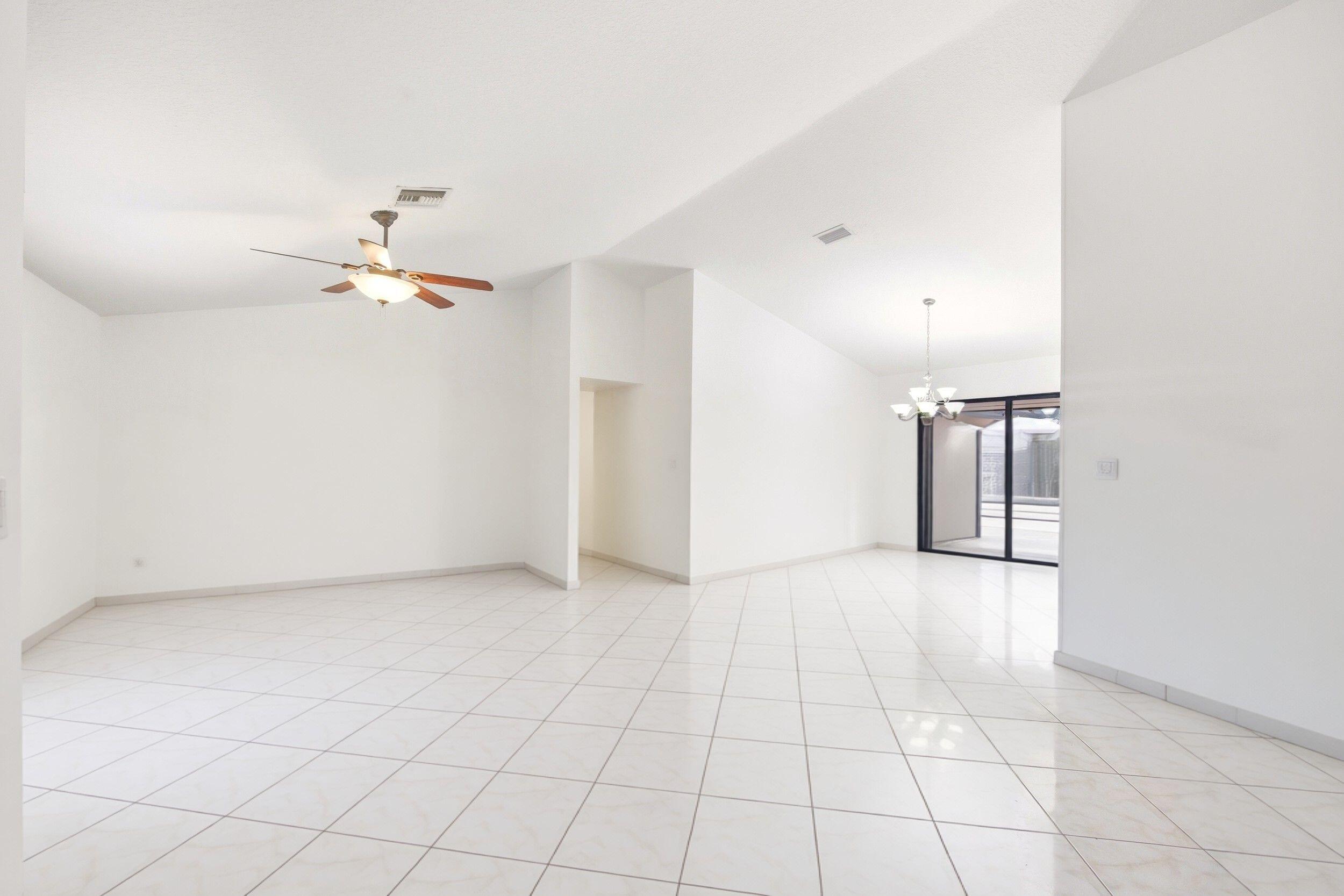 375 Northwest 53rd Street Boca Raton, FL 33487 - Photo 10 of 14 an empty room with a ceiling fan and carpet