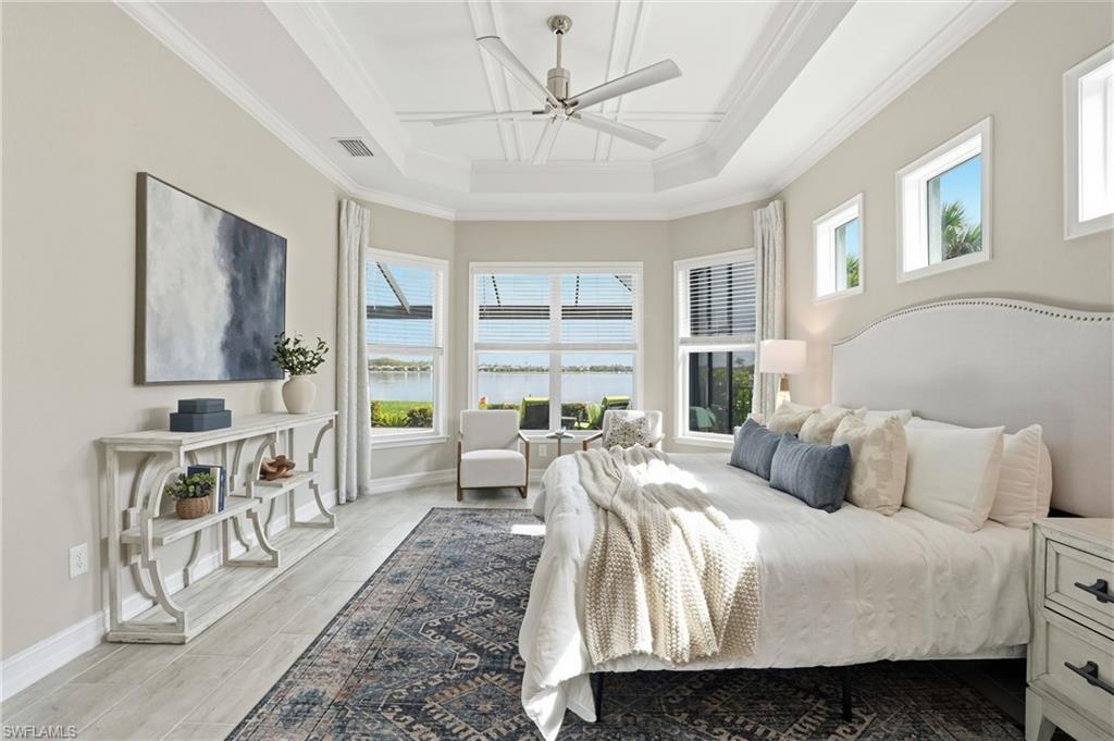 14882 Blue Bay Circle Fort Myers, FL 33913 - Photo 19 of 50 a bedroom with a bed a large window with table and chairs