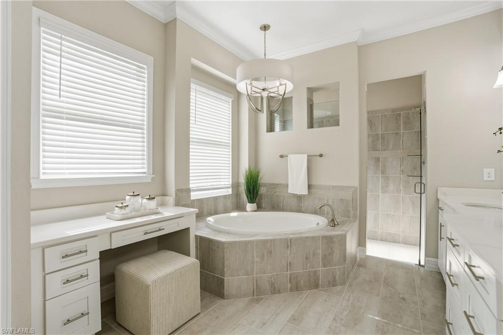 14882 Blue Bay Circle Fort Myers, FL 33913 - Photo 21 of 50 a spacious bathroom with a double vanity sink large mirror and a bathtub