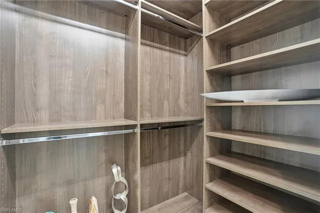 a spacious en suite bathroom with double sink and a mirror