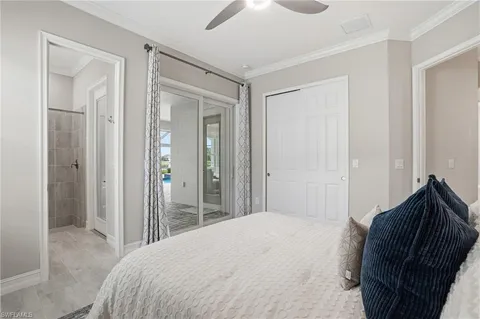 a bedroom with a large bed and a chandelier