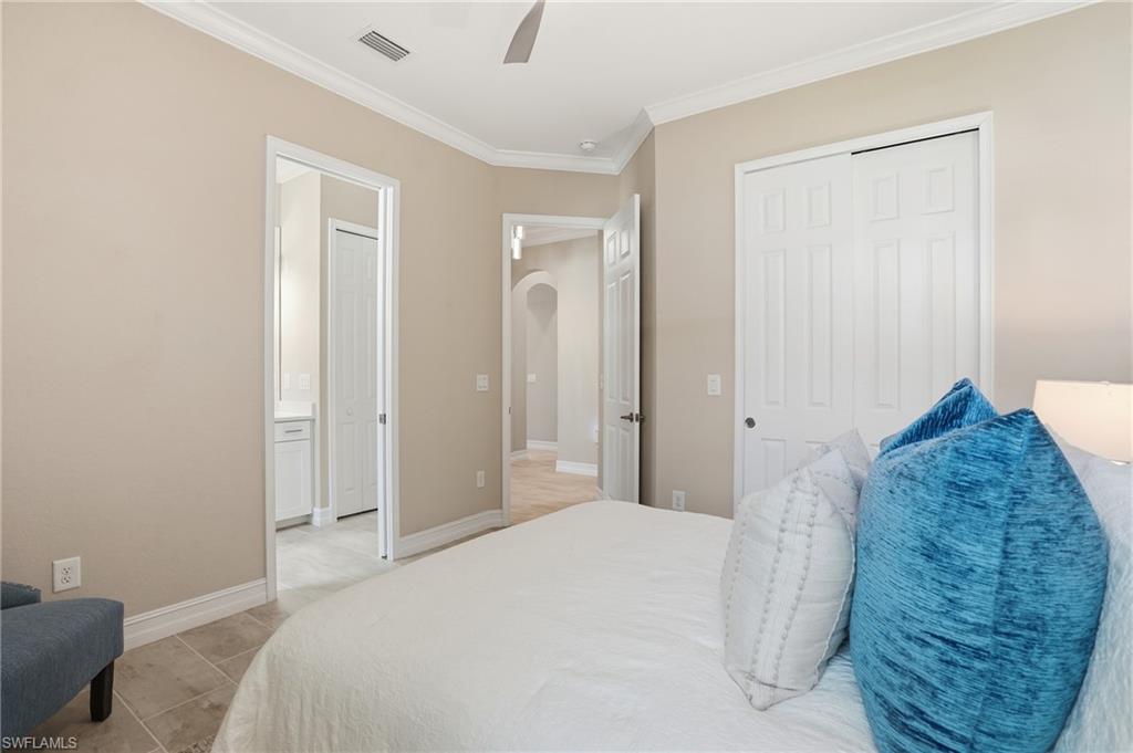 14882 Blue Bay Circle Fort Myers, FL 33913 - Photo 28 of 50 a bedroom with a bed and a mirror