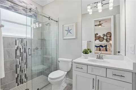 a bedroom with a bed and a mirror