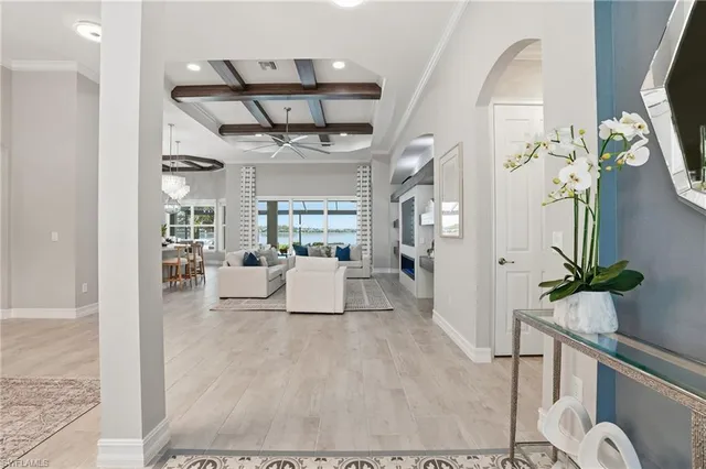 a living room with furniture and a chandelier