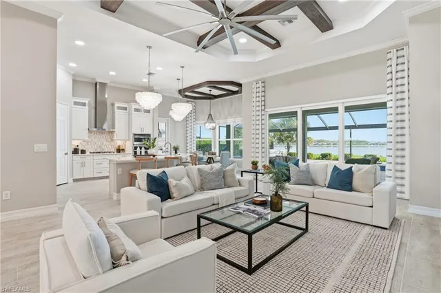 a living room with furniture and a large window with wooden floor