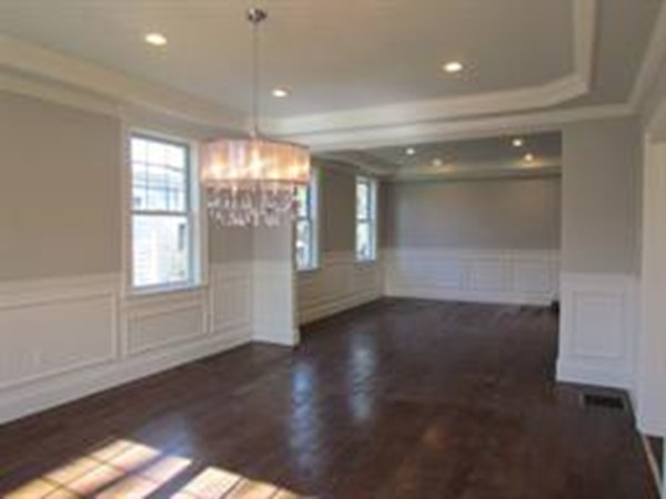 24 Gary Road Needham, MA 02494 - Photo 3 of 8 a view of an empty room with wooden floor and a window