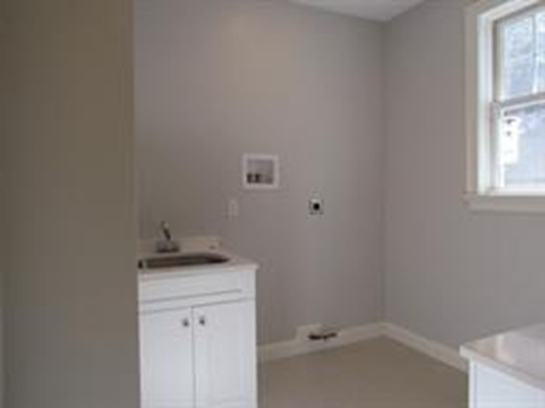 24 Gary Road Needham, MA 02494 - Photo 5 of 8 a bathroom with a sink and cabinets