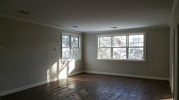 24 Gary Road Needham, MA 02494 - Photo 7 of 8 an empty room with wooden floor and windows