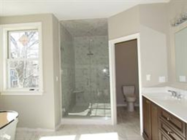 24 Gary Road Needham, MA 02494 - Photo 8 of 8 a bathroom with a granite countertop sink a toilet and shower