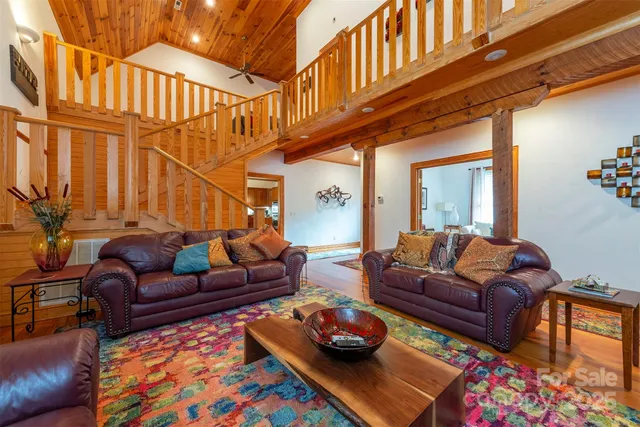 a living room with furniture a rug and a window