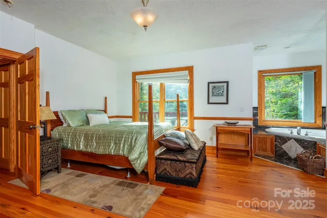 a bedroom with two beds and a large window