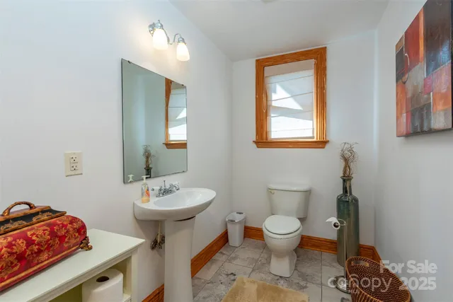 a bathroom with a sink toilet and a mirror