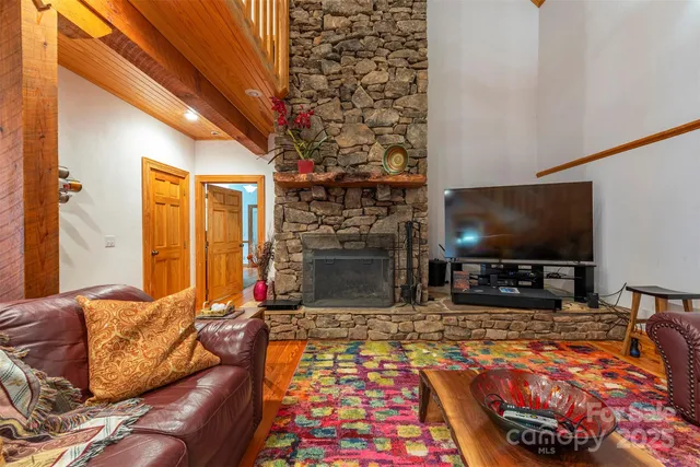 a living room with fireplace furniture and a flat screen tv