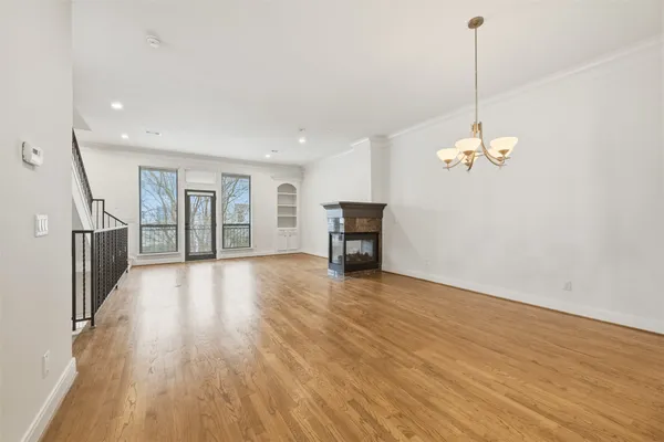 a view of a room with wooden floor and a ceiling fan