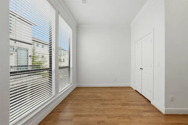 a view of a room with wooden floor and windows