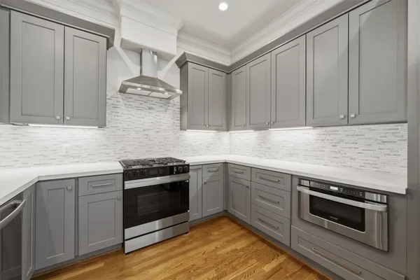 a kitchen with granite countertop stainless steel appliances and cabinets
