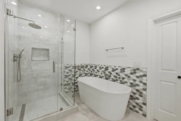 a bathroom with a bathtub and a shower