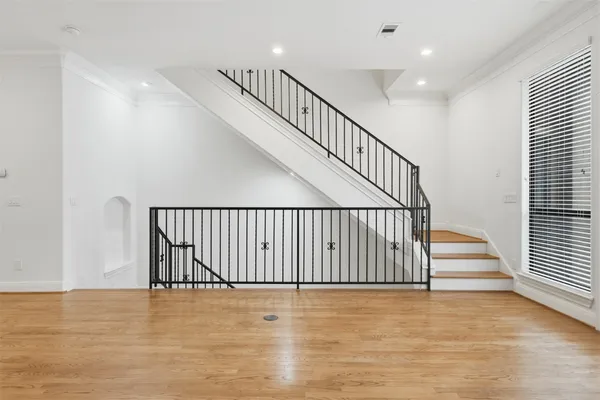 a view of entryway and hall with wooden floor