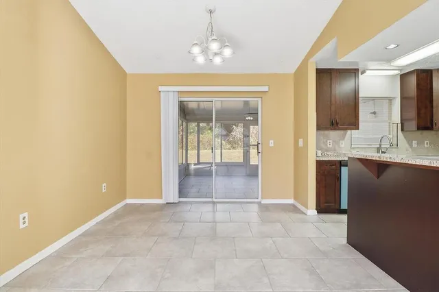 a view of a hallway to rooms and wooden floor