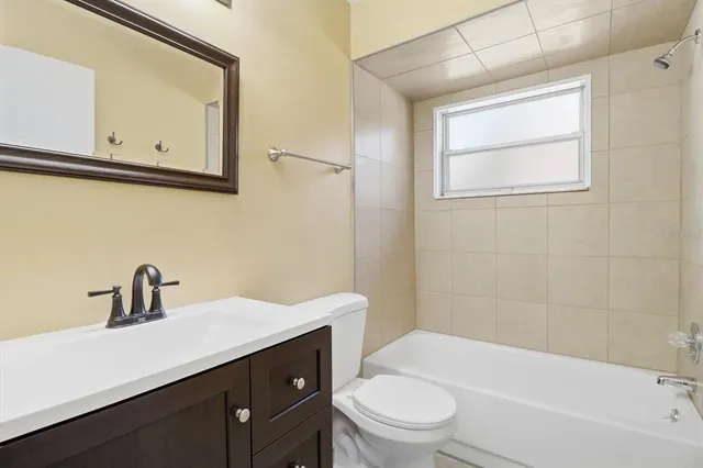 a bathroom with a sink a toilet and bathtub
