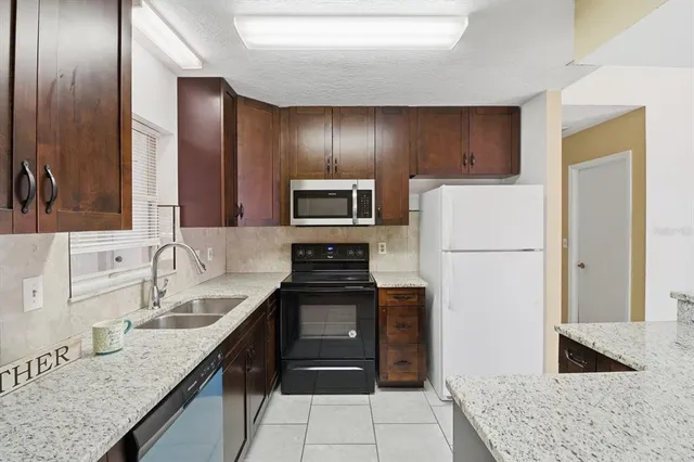 a kitchen with a sink stove and refrigerator