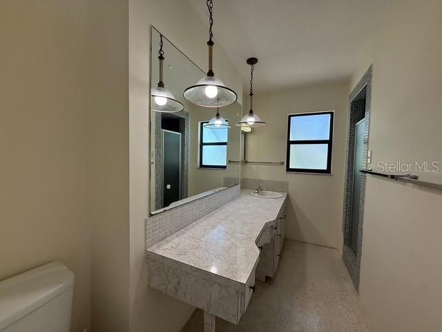 191 Maria Court Punta Gorda, FL 33950 - Photo 12 of 24 a dining room with wooden floor a chandelier a wooden table and chairs