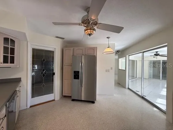 a view of a livingroom with a ceiling fan and entryway
