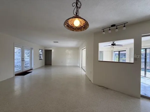 a view of a livingroom with a ceiling fan and window