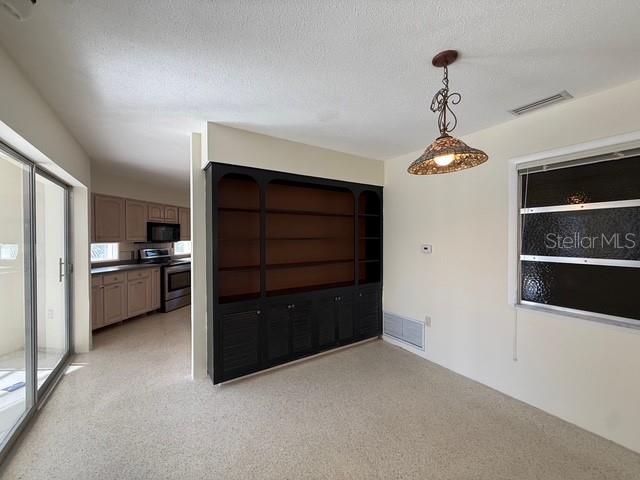 191 Maria Court Punta Gorda, FL 33950 - Photo 9 of 24 a view of a kitchen with a refrigerator and cabinets