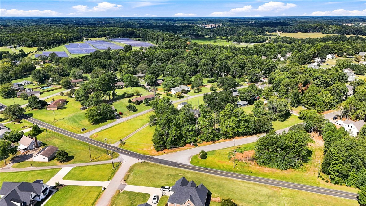 205 Timms Road Piedmont, SC 29673 - Photo 33 of 36 An aerial perspective showcases a lush neighborhood nestled among mature trees and rolling green lawns.