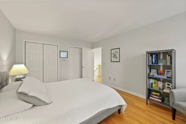 a bedroom with a bed and a book shelf