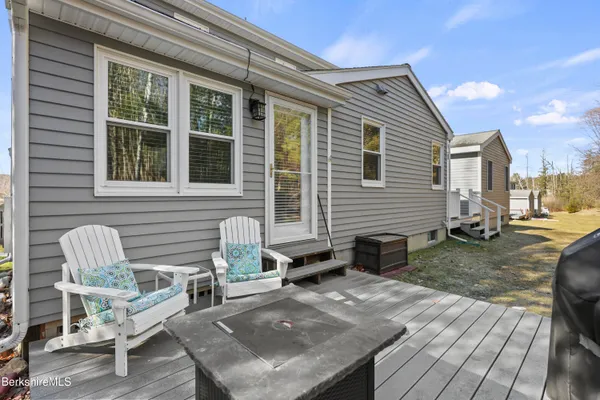 a view of house with backyard and sitting area