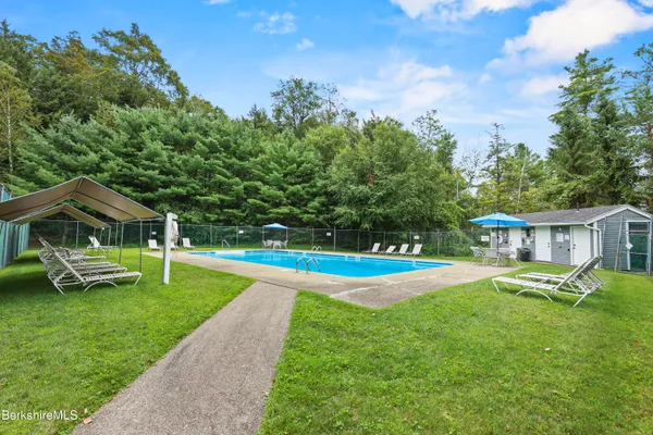 a view of a house with swimming pool and porch