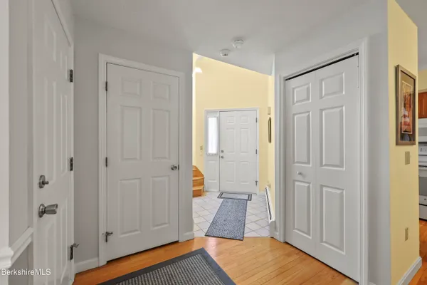 a view of a bedroom with wooden floor and cabinet