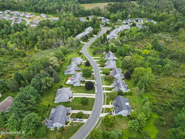 an aerial view of residential house with outdoor space and swimming pool