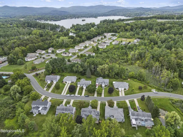 an aerial view of multiple houses with yard
