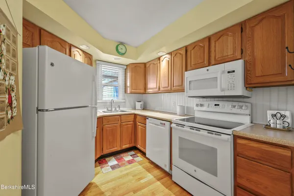 a kitchen with stainless steel appliances granite countertop a refrigerator sink and cabinets