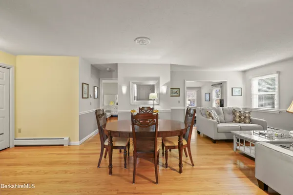 a view of a dining room with furniture and wooden floor