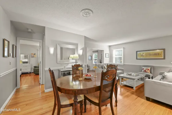 a view of a dining room with furniture and wooden floor