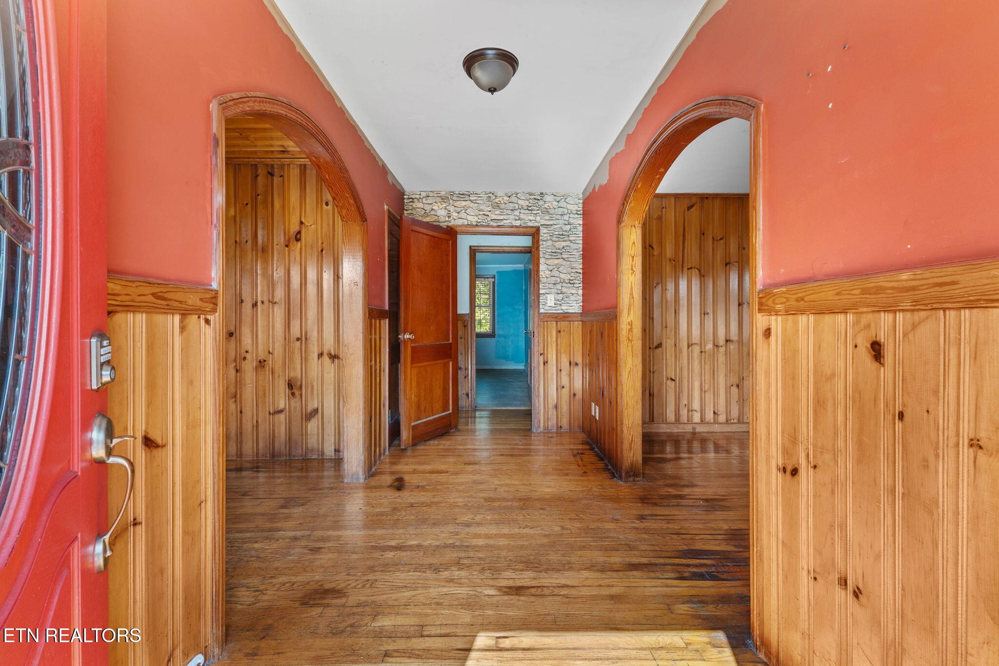 302 Hickory Street Clinton, TN 37716 - Photo 11 of 38 a view of a hallway with wooden floor and staircase