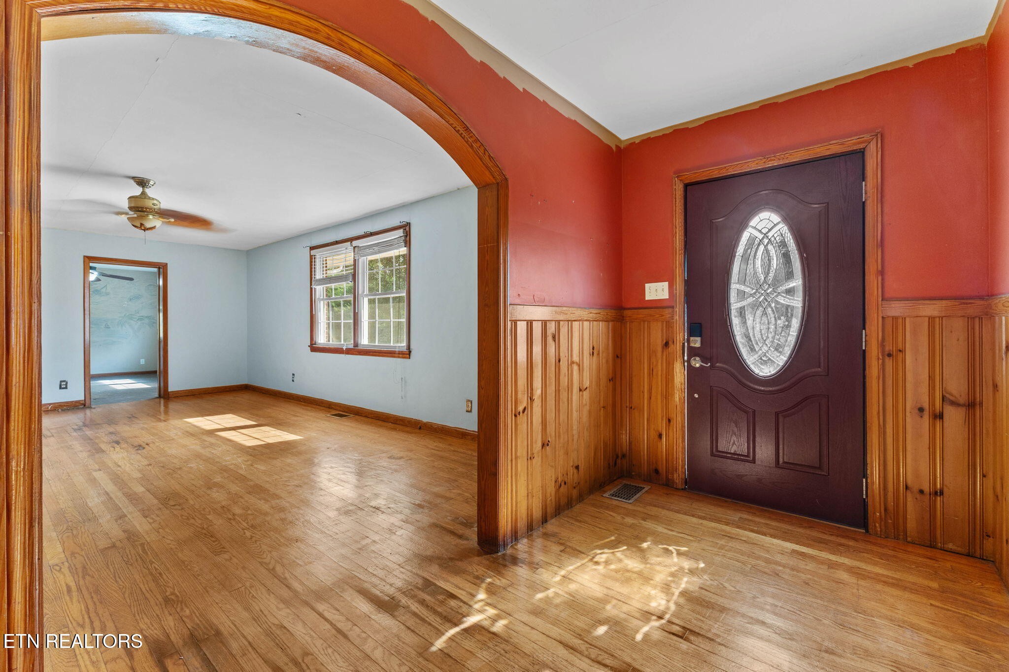 302 Hickory Street Clinton, TN 37716 - Photo 12 of 38 a view of an empty room with a window and wooden floor