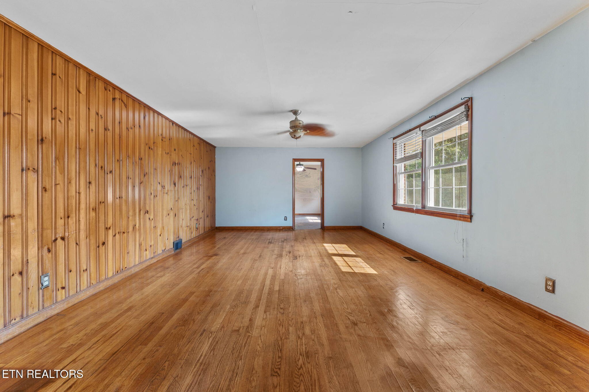 302 Hickory Street Clinton, TN 37716 - Photo 15 of 38 a view of empty room with wooden floor and fan