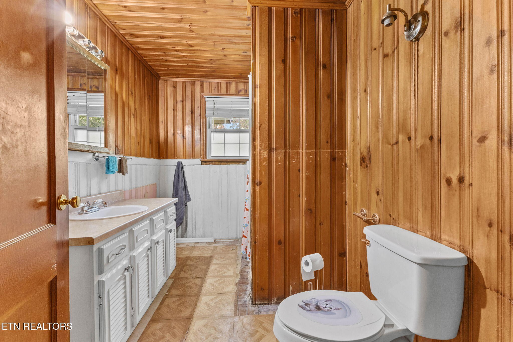 302 Hickory Street Clinton, TN 37716 - Photo 23 of 38 a bathroom with a toilet a sink and a shower curtain