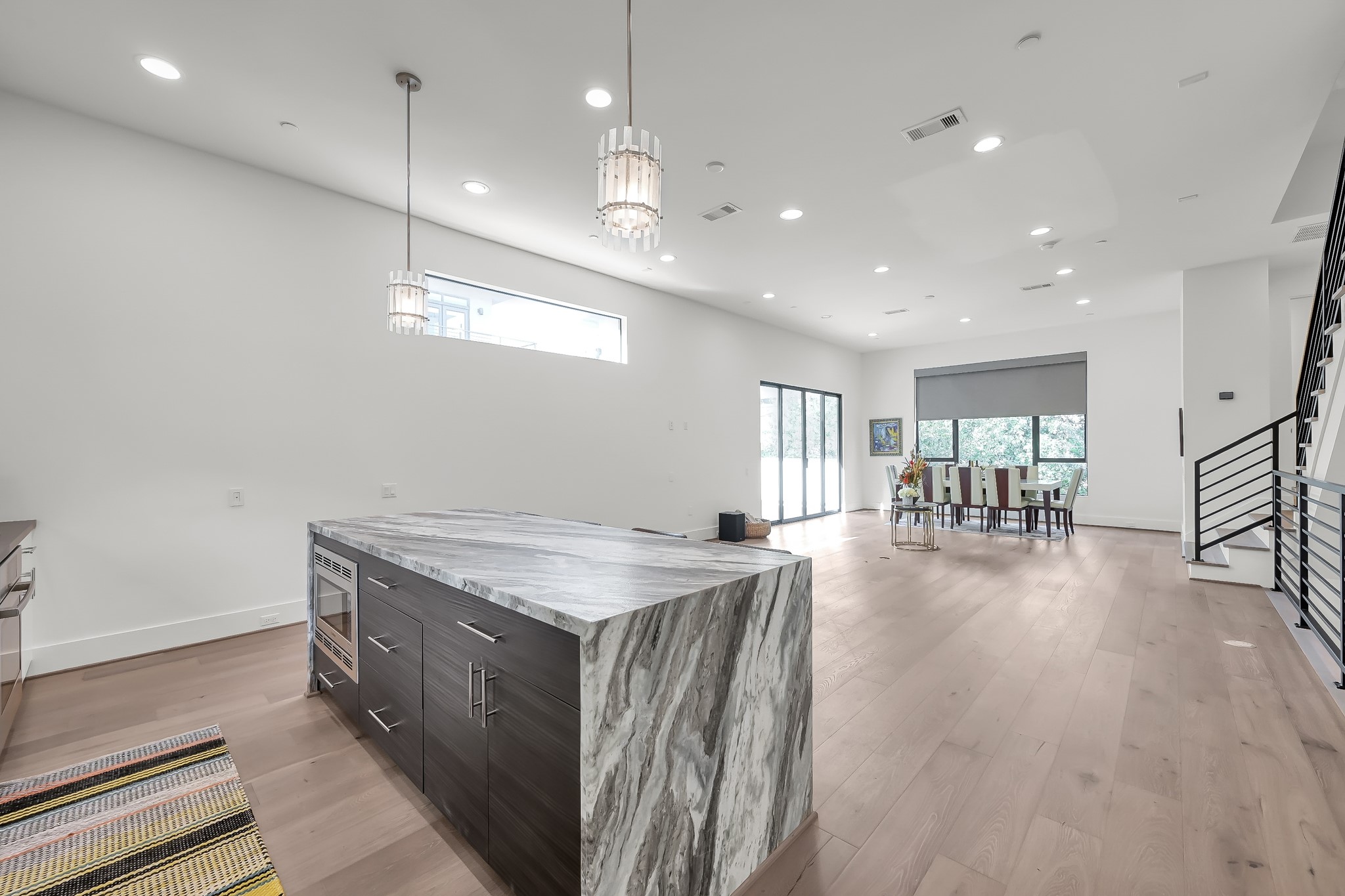 3207 Revere Street Houston, TX 77098 - Photo 20 of 50 a kitchen with a table chairs refrigerator and wooden floor