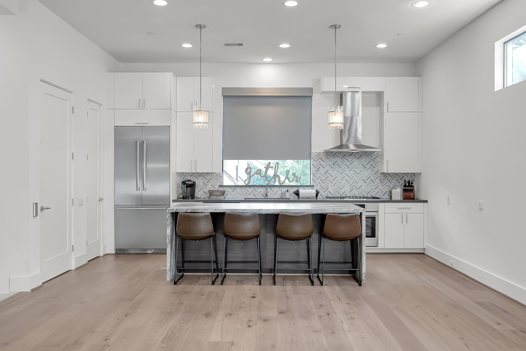 3207 Revere Street Houston, TX 77098 - Photo 21 of 50 a kitchen with granite countertop a table chairs sink and cabinets